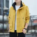 Men's outdoor hooded waterproof windbreaker jacket with contrast pocket details for autumn. - M / Turmeric