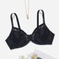 Close-up detail of black lace full-cup bra featuring delicate straps and bow accent. - 38/85C / Black