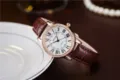 Women quartz watch with brown leather strap, white Roman dial and rhinestone bezel. - Brown