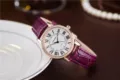 Women's luxury quartz watch featuring purple leather strap, Roman numerals and rhinestones. - Purple
