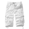 White cotton cargo shorts detail, multi-pocket design with adjustable drawstring cuffs. - White