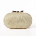 Gold glitter evening clutch bag detail view showcasing elegant metallic bow clasp design. - 19x7x12cm / Gold