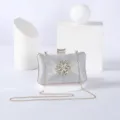 Silver glitter evening clutch bag with sparkling crystal flower clasp and gold chain strap. - Silver