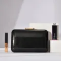 Minimalist black evening clutch bag with gold clasp, elegant design for party and wedding. - Black