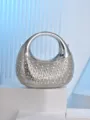 Detailed view of the silver metallic crescent evening bag, sparkling rhinestone embellishment. - Silver