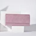 Detailed view of pink glitter evening clutch bag showcasing delicate textured surface fabric. - Pink