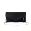 Detailed close-up view of black glitter suede evening clutch with gold chain strap. - Black