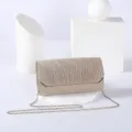 Detailed view of sparkly glitter evening clutch bag with metallic chain strap for women. - Gold