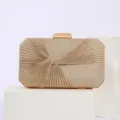Detail view of the elegant gold glitter pleated evening clutch bag with metallic clasp for events. - Gold
