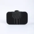 Black beaded evening clutch bag with sparkling rhinestone stripes and metal clasp closure. - Black