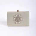 Rhinestone evening clutch bag detail, gold glitter surface with crystal flower decoration. - Champagne
