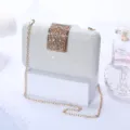 Silver glitter evening clutch bag with rhinestone clasp and gold chain strap for parties. - Silver