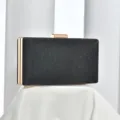 Black glitter evening clutch detail, featuring elegant gold metal frame and secure clasp. - Black