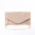 Close-up detail of the shimmering suede evening clutch bag, showing fine glitter texture and gold chain. - Apricot