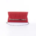 Detailed shot of the red glitter evening clutch bag with metallic bar and chain strap. - Red