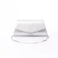 Silver envelope clutch bag detail showing metallic chain strap and smooth texture. - Silver