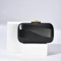 Elegant black evening clutch bag for women with gold tone lock and wave texture design. - 18x10.5x5.5cm / Black