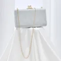 Silver sparkly evening clutch bag with chic chain strap and crystal clasp detail. - Silver