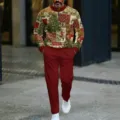 Detailed view of men's vintage Christmas theme zip-collar sweatshirt and red trouser set. - Vintage Collage