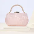 Pink rhinestone handle evening clutch bag detail, elegant satin texture and shiny metallic clasp. - Pink