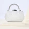 Elegant silver rhinestone handle clutch bag detail, showing exquisite metallic lock. - Silver