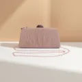 Close-up of pink glitter evening clutch showing pleated design and metallic chain strap details. - Gold