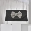 Exquisite black glitter evening clutch featuring a dazzling crystal bow, detailed close-up shot. - Black