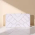 Detailed view of an elegant pearl and rhinestone embellished evening envelope clutch bag. - Silver