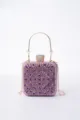 Detail view of a stunning purple crystal evening clutch bag with gold handle and chain strap. - Purple