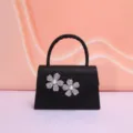 Black glitter evening bag featuring exquisite rhinestone pearl flowers and a classic handle design. - Black