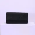 Details of black glitter evening clutch bag, elegant accessory showing fine sparkling texture. - 20x6x10cm / Black