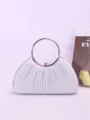 Detail view of silver pleated evening clutch bag with elegant metal ring handle. - Silver