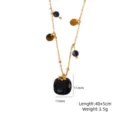 Gold-tone chain necklace featuring a faceted black stone pendant and dainty charm details. - Black Agate