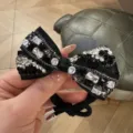 Elegant black bow hair tie featuring sparkling rhinestones, perfect for chic daily updos and buns. - Black