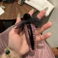 Molletta per capelli nera con strass rosa brillanti e un elegante fiocco nero trasparente. - Rosa