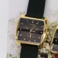 Close-up view of womens square quartz watch with golden case and black silicone strap details. - Gold Case Black Dial Black Strap