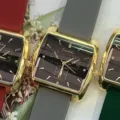 Close-up detail of women square quartz watch with comfortable silicone strap and golden bezel. - Gold Case Black Dial Grey Strap