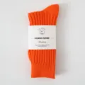 Vibrant orange ribbed crew socks with paper band label, casual knit streetwear style. - One Size / Solid Orange