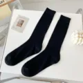 Black ribbed crew socks, simple style, comfortable cotton blend material for daily wear. - One Size / Black