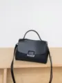 Elegant black leather top-handle handbag with shoulder strap for women daily wear. - Black