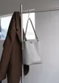 Grey leather bucket bag for women, featuring a spacious interior and metal lock closure. - Light Apricot