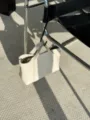 Close-up detail of minimalist cream leather tote handbag hanging on modern chair scene. - 24*6*17CM / Off White