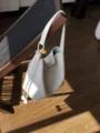 Minimalist white leather hobo shoulder bag with casual drawstring ball design for women. - Off White
