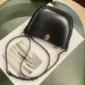 Black leather saddle bag detail, elegant gold metal clasp and adjustable slender shoulder strap. - Black