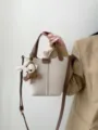 Genuine leather bucket bag, beige and brown crossbody handbag with cute charm accessory. - Ivory