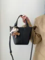 Black leather bucket bag for women, stylish shoulder crossbody bag with cute bear charm - Black
