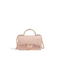 Detail view of the pink quilted leather handbag featuring a gold chain handle and classic design. - Pink