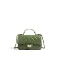 Green quilted leather handbag detail view, featuring metallic chain and classic turn-lock closure. - Green