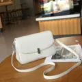 Stylish genuine leather crossbody bag for women, elegant white shoulder bag with flap design. - White