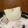 White leather saddle bag with metal clasp, elegant single shoulder crossbody bag for women. - Off White